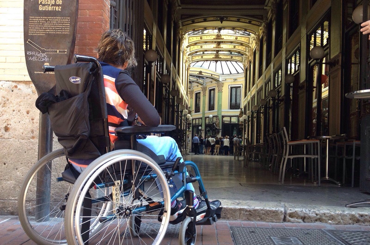 Mujer en silla de ruedas accediendo a Pasaje de Gutierrez, galería emblemática de Valladolid